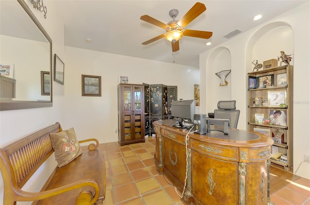 tiled home office featuring ceiling fan