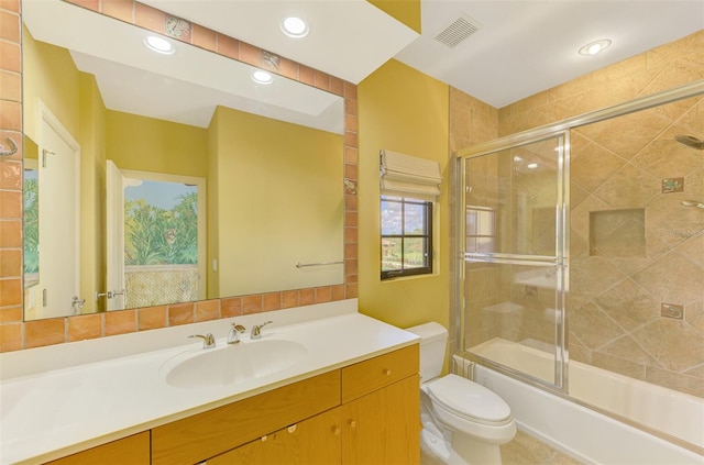 full bathroom with vanity, combined bath / shower with glass door, and toilet