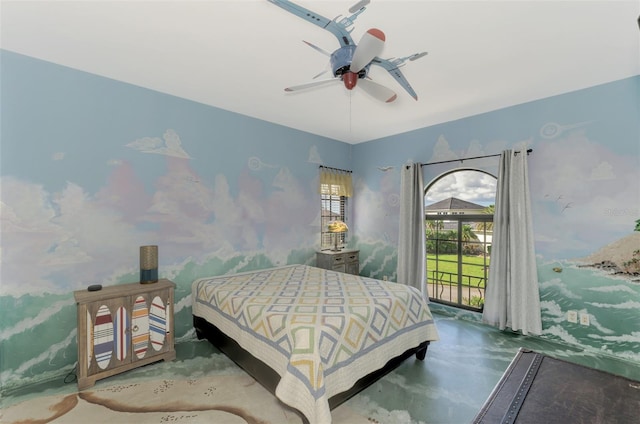 bedroom featuring access to exterior, ceiling fan, and concrete floors