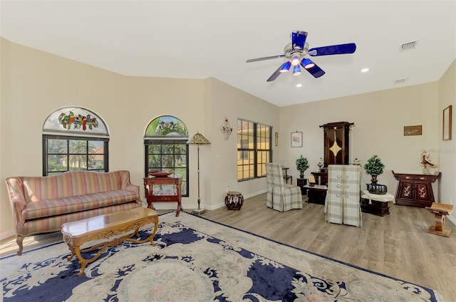 living room featuring hardwood / wood-style flooring and ceiling fan