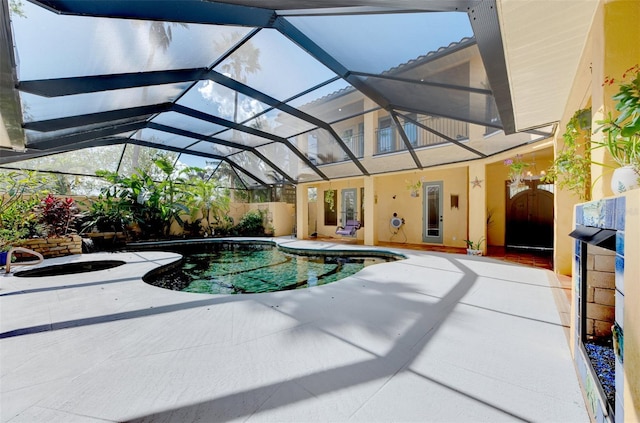 view of pool featuring glass enclosure and a patio area