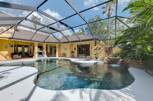 view of swimming pool featuring glass enclosure, french doors, a hot tub, pool water feature, and a patio area