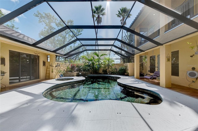 view of pool with a patio area, a lanai, and an in ground hot tub