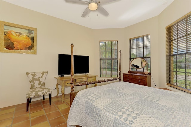 bedroom with ceiling fan and light tile patterned flooring