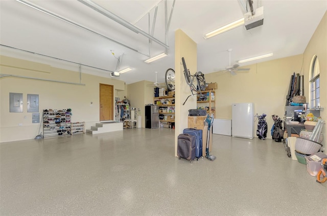 garage with ceiling fan, a garage door opener, and stainless steel refrigerator