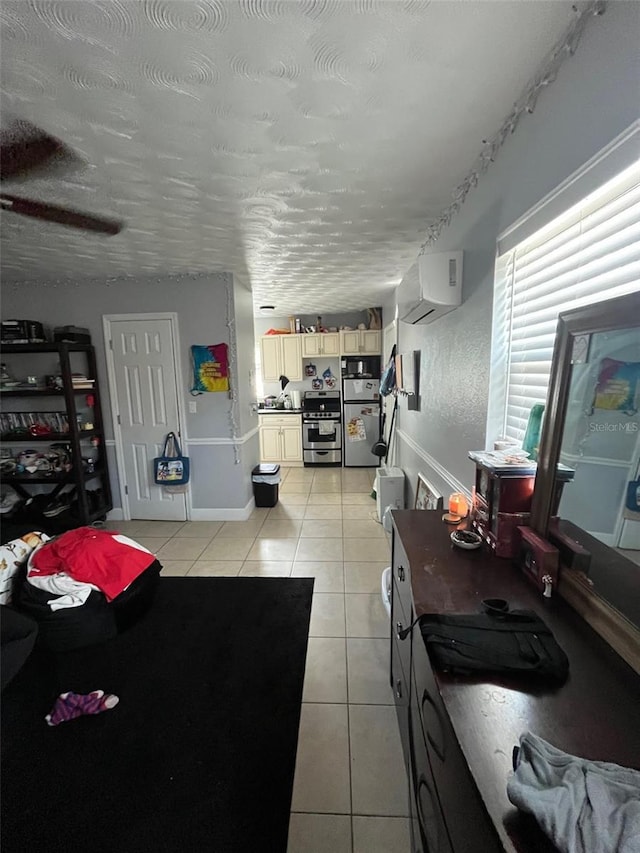 tiled living room with a textured ceiling and an AC wall unit