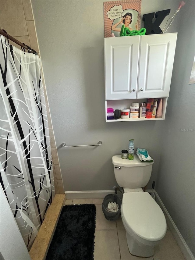 bathroom with tile patterned flooring, curtained shower, and toilet