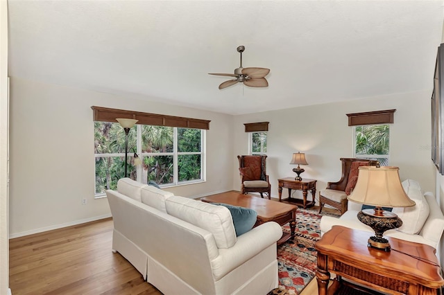 living room featuring light wood-type flooring and ceiling fan