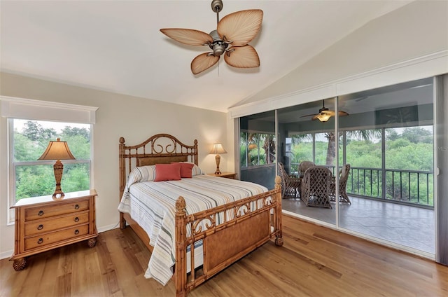 bedroom featuring lofted ceiling, multiple windows, hardwood / wood-style flooring, and ceiling fan