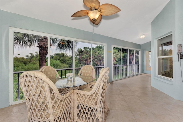 sunroom / solarium featuring ceiling fan, vaulted ceiling, and a healthy amount of sunlight