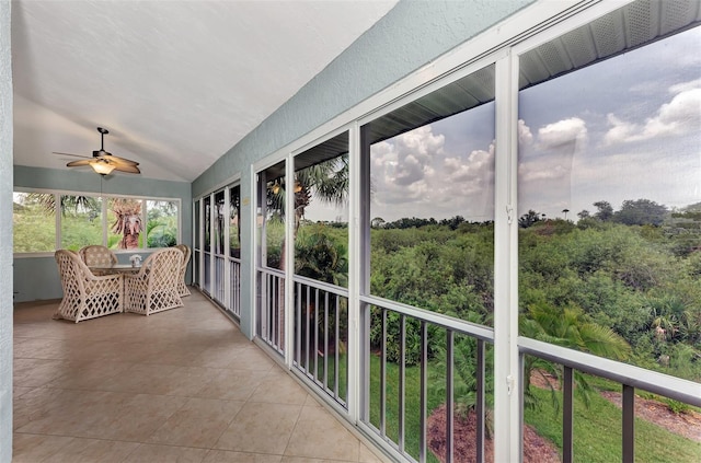 sunroom with ceiling fan and vaulted ceiling