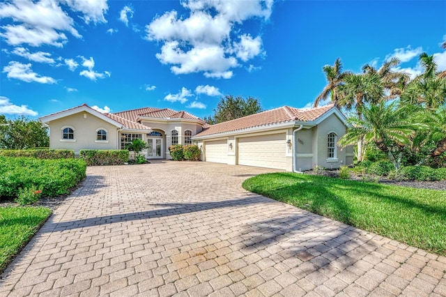 mediterranean / spanish-style house with french doors and a garage