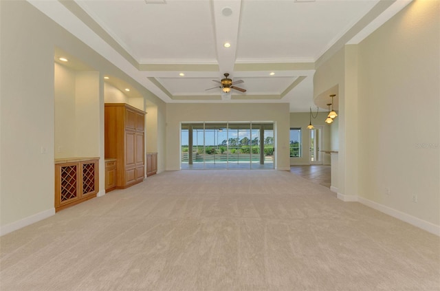 unfurnished living room featuring ceiling fan, crown molding, and light colored carpet