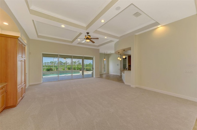 unfurnished living room with ceiling fan, coffered ceiling, beamed ceiling, crown molding, and light carpet