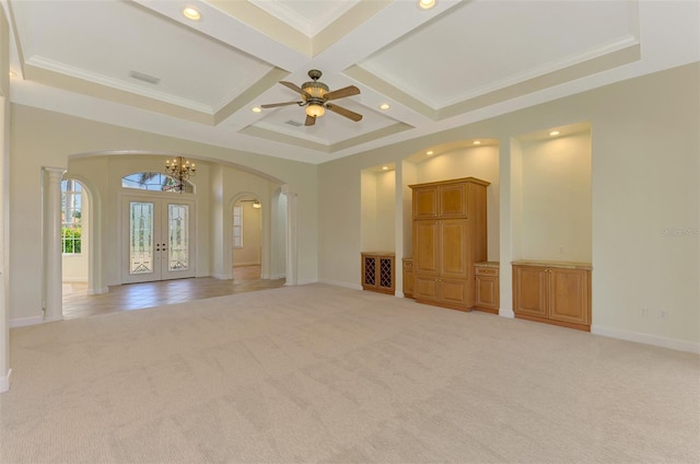 unfurnished living room with light colored carpet, ornamental molding, french doors, and coffered ceiling