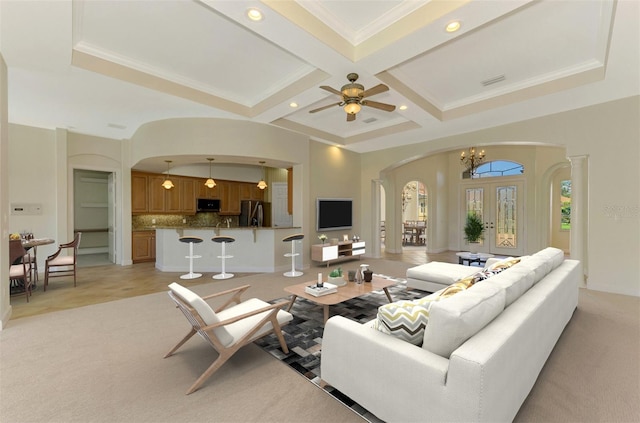 living room with french doors, coffered ceiling, ceiling fan with notable chandelier, crown molding, and beamed ceiling