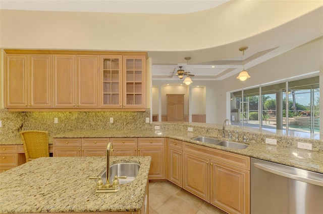 kitchen with stainless steel dishwasher, pendant lighting, a center island with sink, and sink