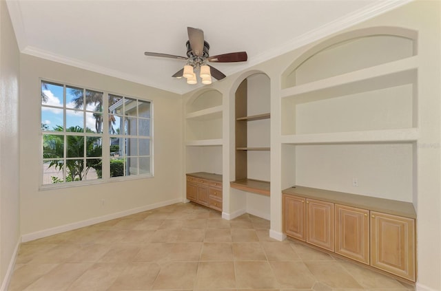 tiled spare room with built in shelves, ceiling fan, and ornamental molding