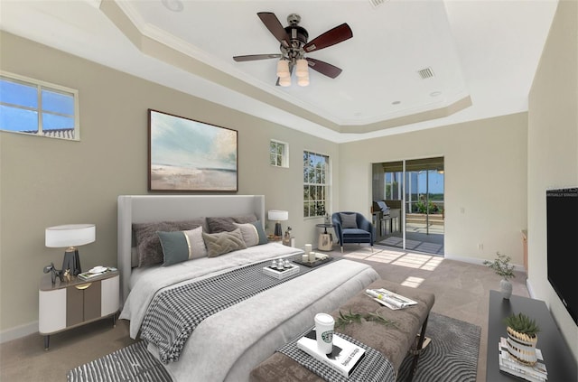 carpeted bedroom with ceiling fan, access to exterior, crown molding, and a tray ceiling