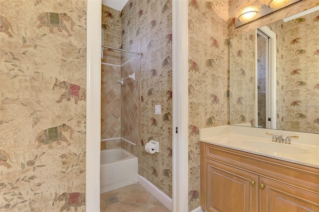 bathroom with tile patterned flooring, vanity, and tiled shower / bath combo