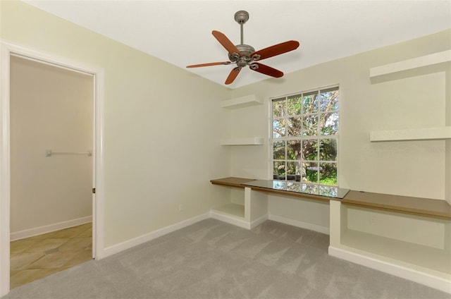 unfurnished office featuring light colored carpet and ceiling fan