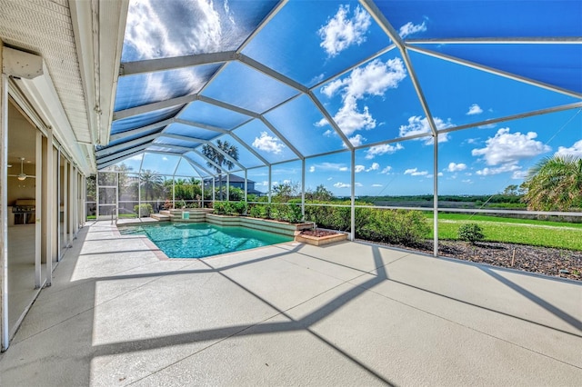 view of swimming pool with glass enclosure and a patio