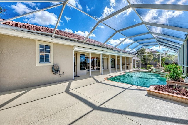 view of swimming pool with glass enclosure and a patio area