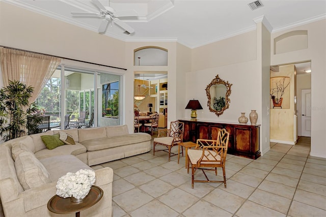 tiled living room with a towering ceiling, ceiling fan, and crown molding