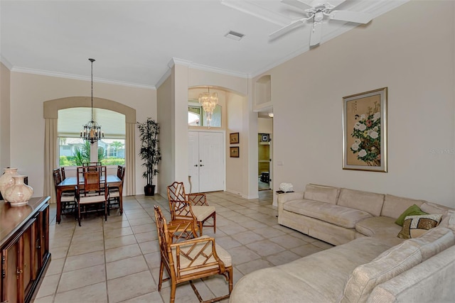 tiled living room featuring ceiling fan with notable chandelier and crown molding