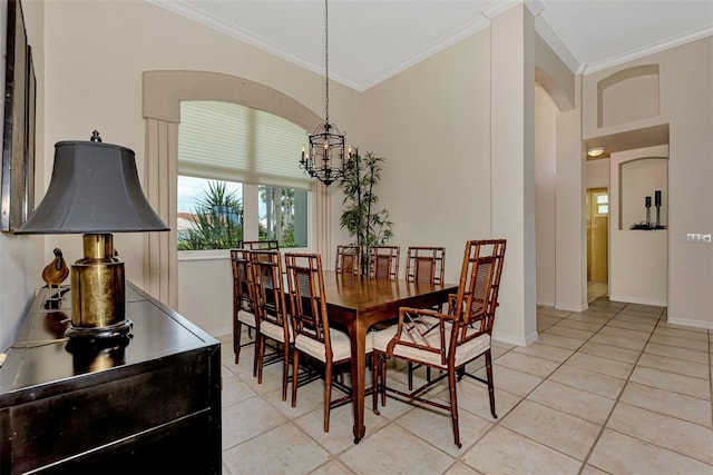 tiled dining area featuring crown molding and a notable chandelier