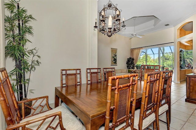 tiled dining area with crown molding and ceiling fan with notable chandelier