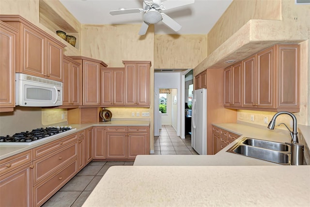 kitchen with ceiling fan, sink, light tile patterned floors, and white appliances