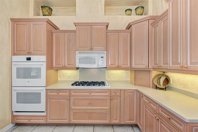 kitchen featuring white appliances and light tile patterned floors