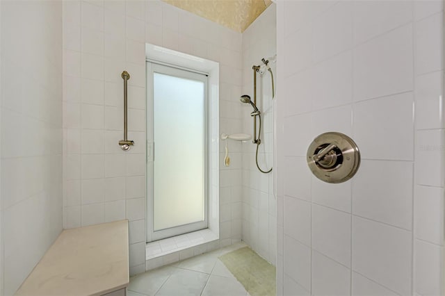 bathroom featuring tile patterned flooring and a tile shower