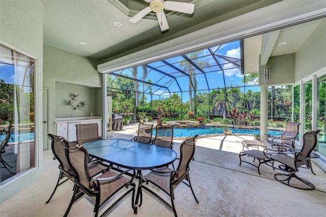 view of patio featuring a lanai, ceiling fan, and a pool with hot tub