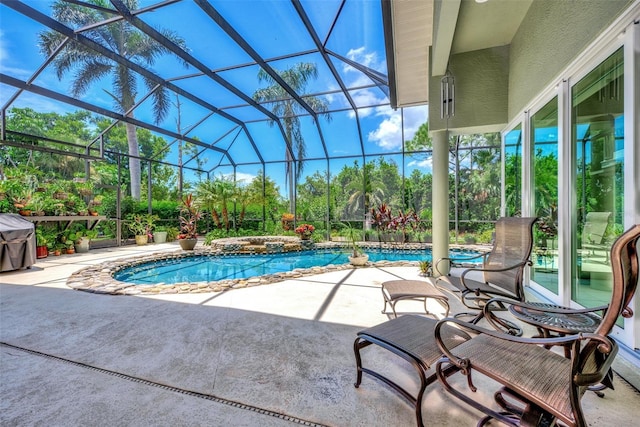 view of pool with a lanai, grilling area, a patio, and an in ground hot tub