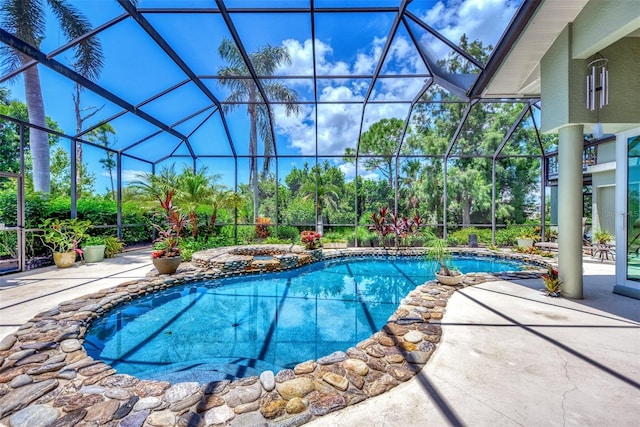 view of swimming pool with a lanai and a patio area