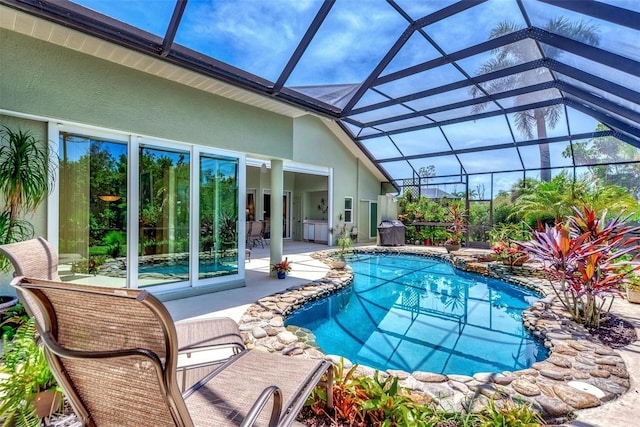 view of swimming pool with a lanai and a patio