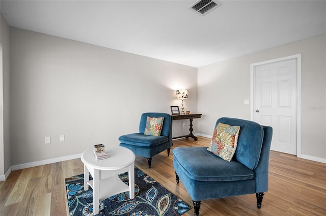 living area with hardwood / wood-style floors