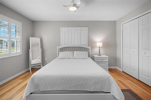 bedroom with ceiling fan, a closet, and light hardwood / wood-style flooring