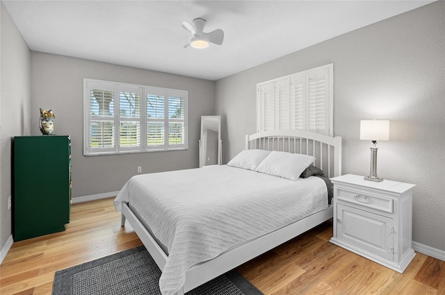 bedroom with light hardwood / wood-style floors and ceiling fan