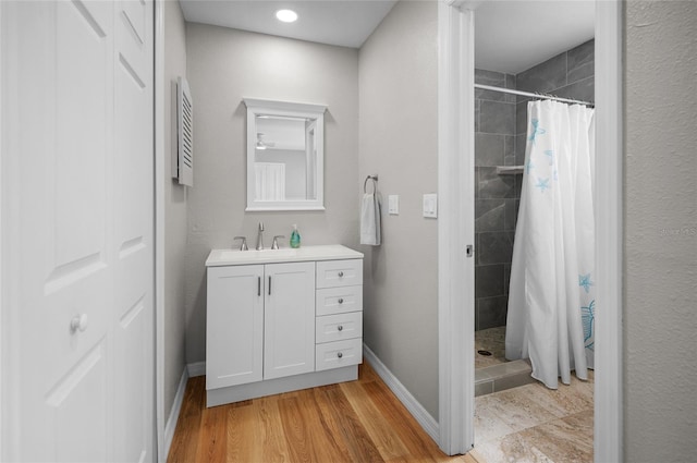 bathroom featuring wood-type flooring, vanity, and a shower with curtain