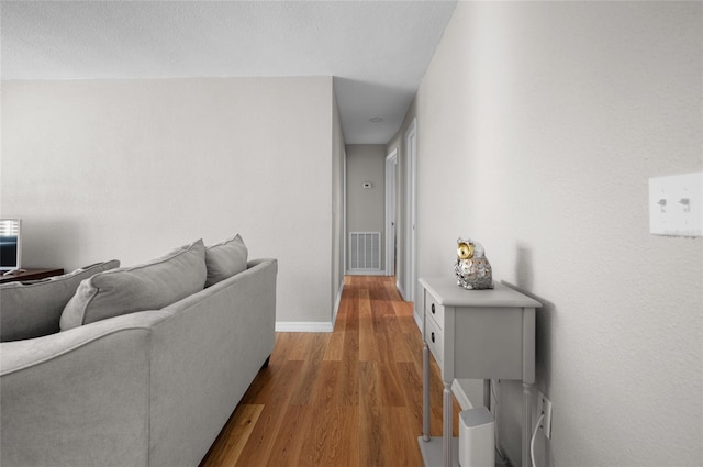 corridor with light wood-type flooring