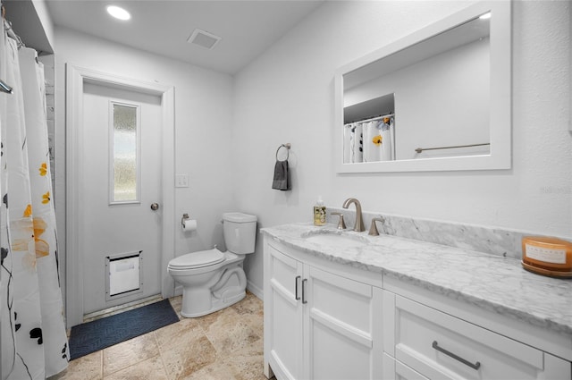 bathroom with toilet and vanity