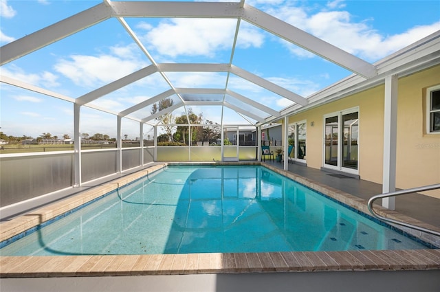 view of swimming pool featuring a lanai