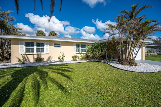 single story home featuring a garage and a front yard