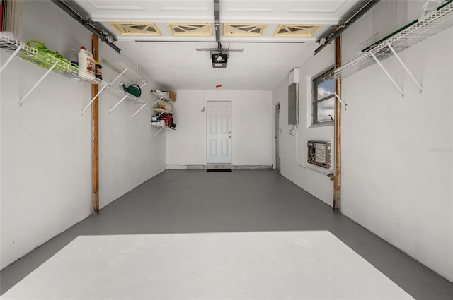 garage with a garage door opener and heating unit