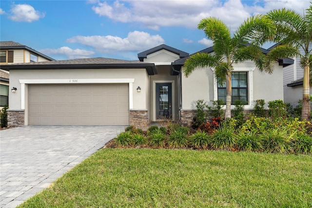 view of front of home featuring a garage and a front lawn