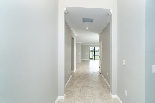 hall with light tile patterned flooring and ornamental molding