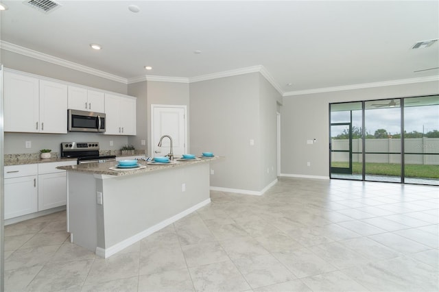 kitchen featuring visible vents, appliances with stainless steel finishes, white cabinetry, and crown molding